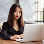 Asian business woman working in laptop in office. Japanese businesswoman