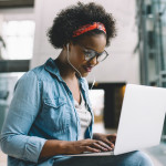 Smiling African student studying for an exam on campus