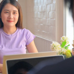 Young female student looked at a friend sitting opposite.They are learning online at home.