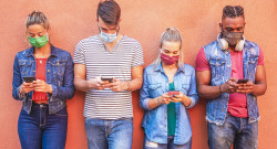 People using apps too much, Picture of young people on a walls looking at their smartphone apps.